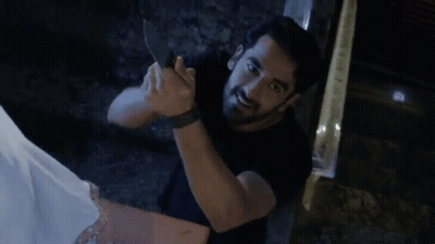 Man In Black Shirt Holding Knife GIF