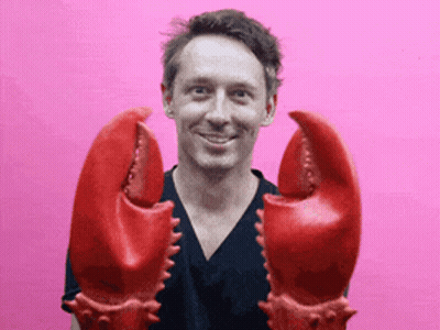 Man In Black Shirt Holding Lobster Claws GIF