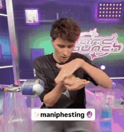 Man In Black Shirt Holding Maniphesting Sign GIF