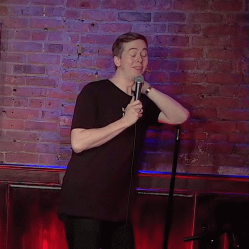 Man In Black Shirt Holding Microphone GIF