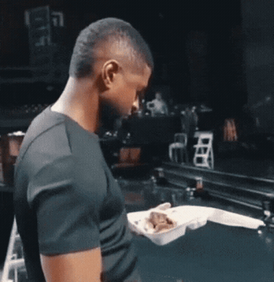 Man In Black Shirt Holding Styrofoam Food Container GIF