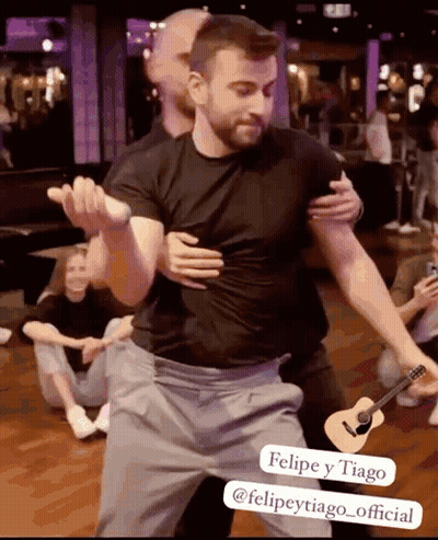 Man In Black Shirt Hugging Another Man With Guitar GIF