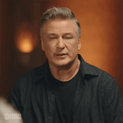 Man In Black Shirt In Front Of Comedy Central Logo GIF