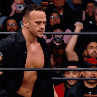 Man In Black Shirt In Front Of Crowd GIF