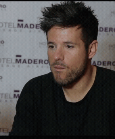 Man In Black Shirt In Front Of Hotel Madero Wall GIF