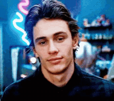 Man In Black Shirt In Front Of Neon Sign GIF