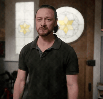 Man In Black Shirt In Front Of Stained Glass Door GIF