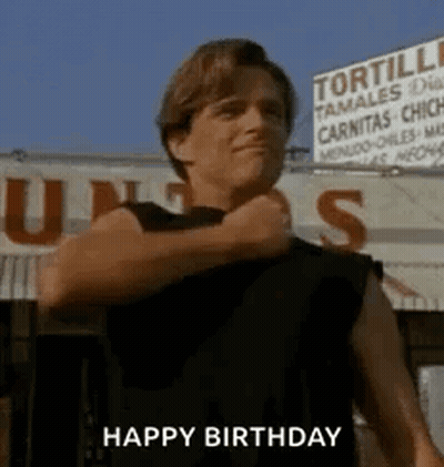 Man In Black Shirt In Front Of Tortilla Tamales Sign GIF