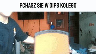 Man In Black Shirt In Front Of TV Saying Pchasz Sie W Gips Kolego GIF