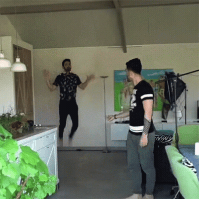 Man In Black Shirt Jumping In Air GIF