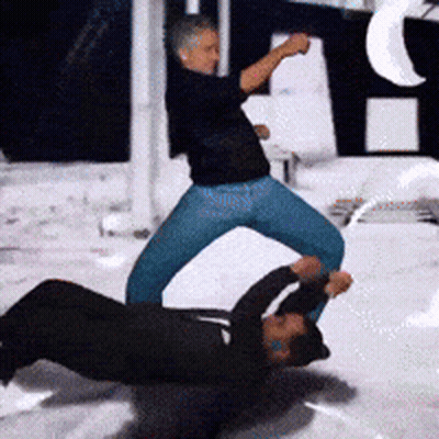 Man In Black Shirt Kicking Another Man GIF