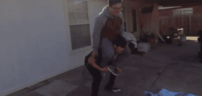 Man In Black Shirt Kneeling Over Woman In Blue Jacket GIF