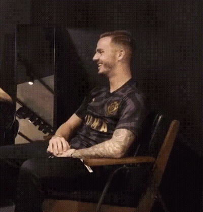 Man In Black Shirt Laughing In Chair GIF