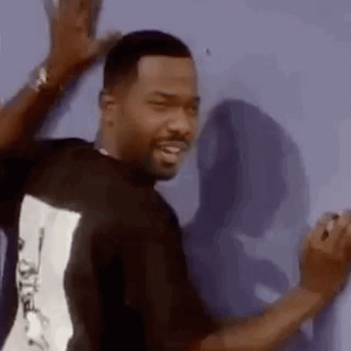 Man In Black Shirt Leaning Against Wall GIF