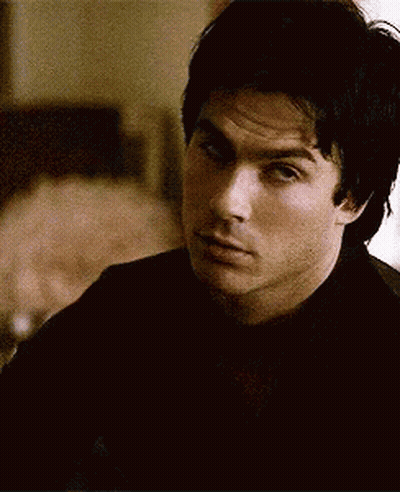 Man In Black Shirt Looking At Camera GIF