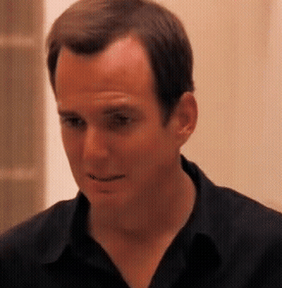 Man In Black Shirt Looking At Camera GIF