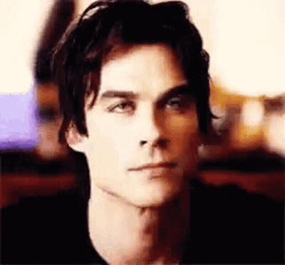 Man In Black Shirt Looking At Camera GIF