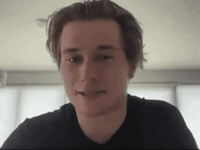 Man In Black Shirt Looking At Camera GIF