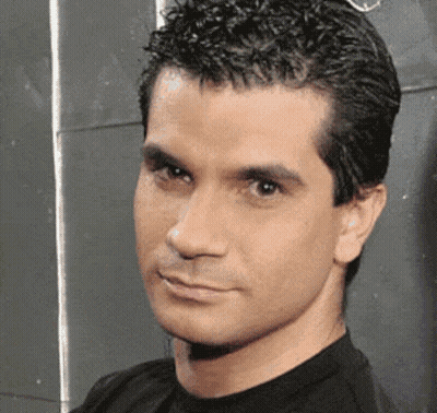Man In Black Shirt Looking At Camera GIF
