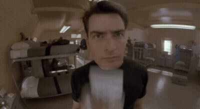 Man In Black Shirt Looking At Camera GIF
