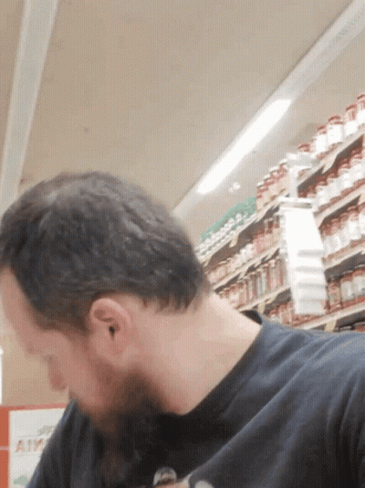 Man In Black Shirt Looking Down GIF