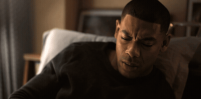 Man In Black Shirt Lying In Hospital Bed GIF