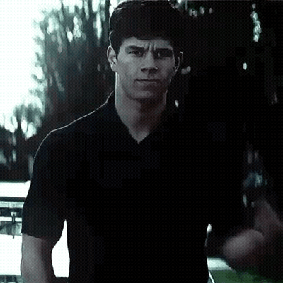 Man In Black Shirt Making Fist In Front Of Car GIF