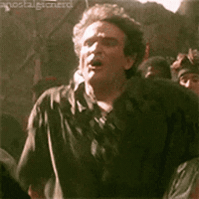 Man In Black Shirt Making Funny Face In Front Of Crowd GIF