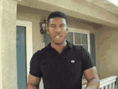 Man In Black Shirt Making Funny Face In Front Of House GIF