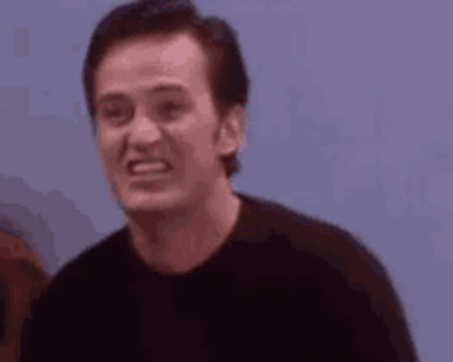 Man In Black Shirt Making Funny Face Next To Woman GIF