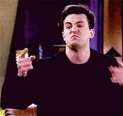 Man In Black Shirt Making Funny Face While Holding Pink Shoes GIF