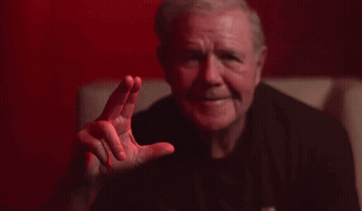 Man In Black Shirt Making Gesture On Couch GIF