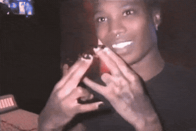 Man In Black Shirt Making Peace Sign GIF