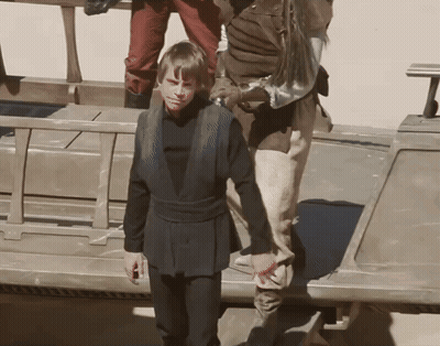 Man In Black Shirt Next To Man In Brown Shirt GIF