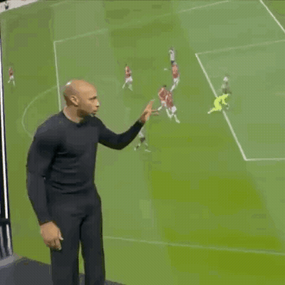 Man In Black Shirt On Soccer Field With Players GIF