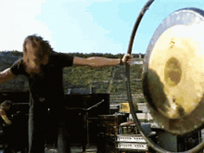 Man In Black Shirt Playing Gong GIF