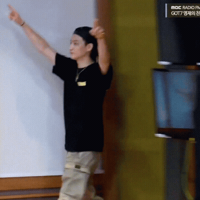 Man In Black Shirt Pointing At MBC Radio FM Sign GIF