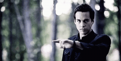 Man In Black Shirt Pointing In Forest GIF