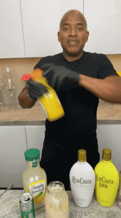 Man In Black Shirt Pouring Rum Chata Into Jar GIF