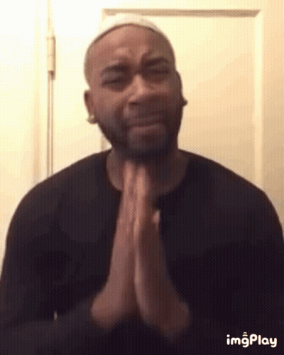 Man In Black Shirt Praying Before Door GIF