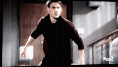 Man In Black Shirt Running Down Stairs GIF