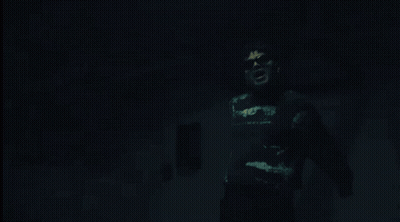 Man In Black Shirt Saying A In Dark Room GIF