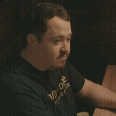 Man In Black Shirt Saying Ally One Sitting At Table GIF