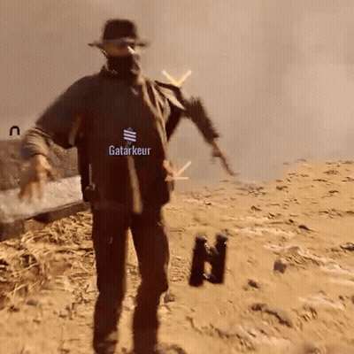 Man In Black Shirt Saying Katarkeur Holding Gun And Binoculars GIF