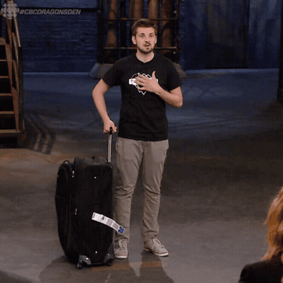 Man In Black Shirt Saying Skyscraper Pushing Suitcase GIF