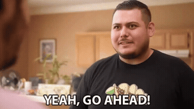 Man In Black Shirt Says Yeah Go Ahead In Kitchen GIF