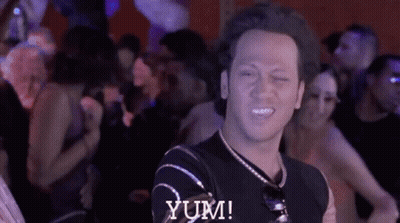 Man In Black Shirt Says Yum In Crowd GIF
