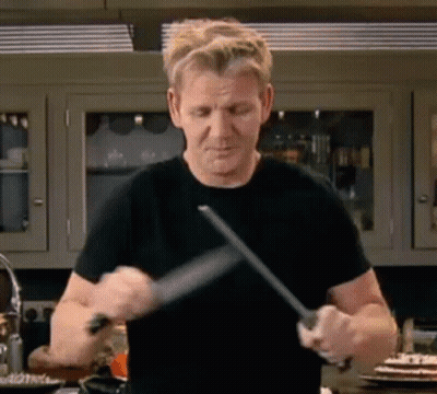 Man In Black Shirt Sharpening Knife GIF