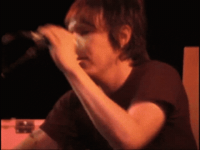 Man In Black Shirt Singing Into Microphone GIF