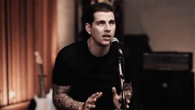 Man In Black Shirt Singing Into Microphone GIF
